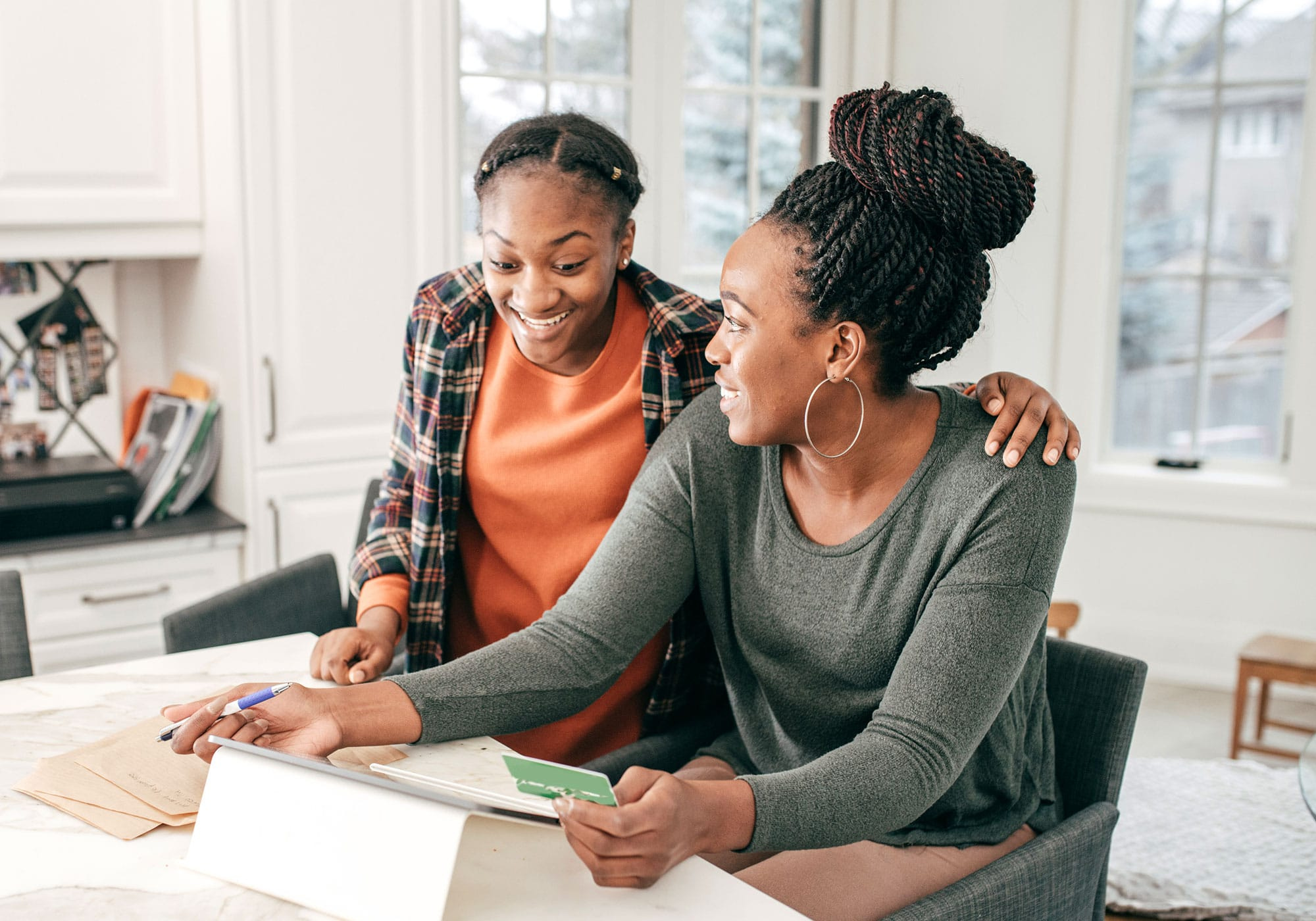 Mother creating a budget with teen daughter.