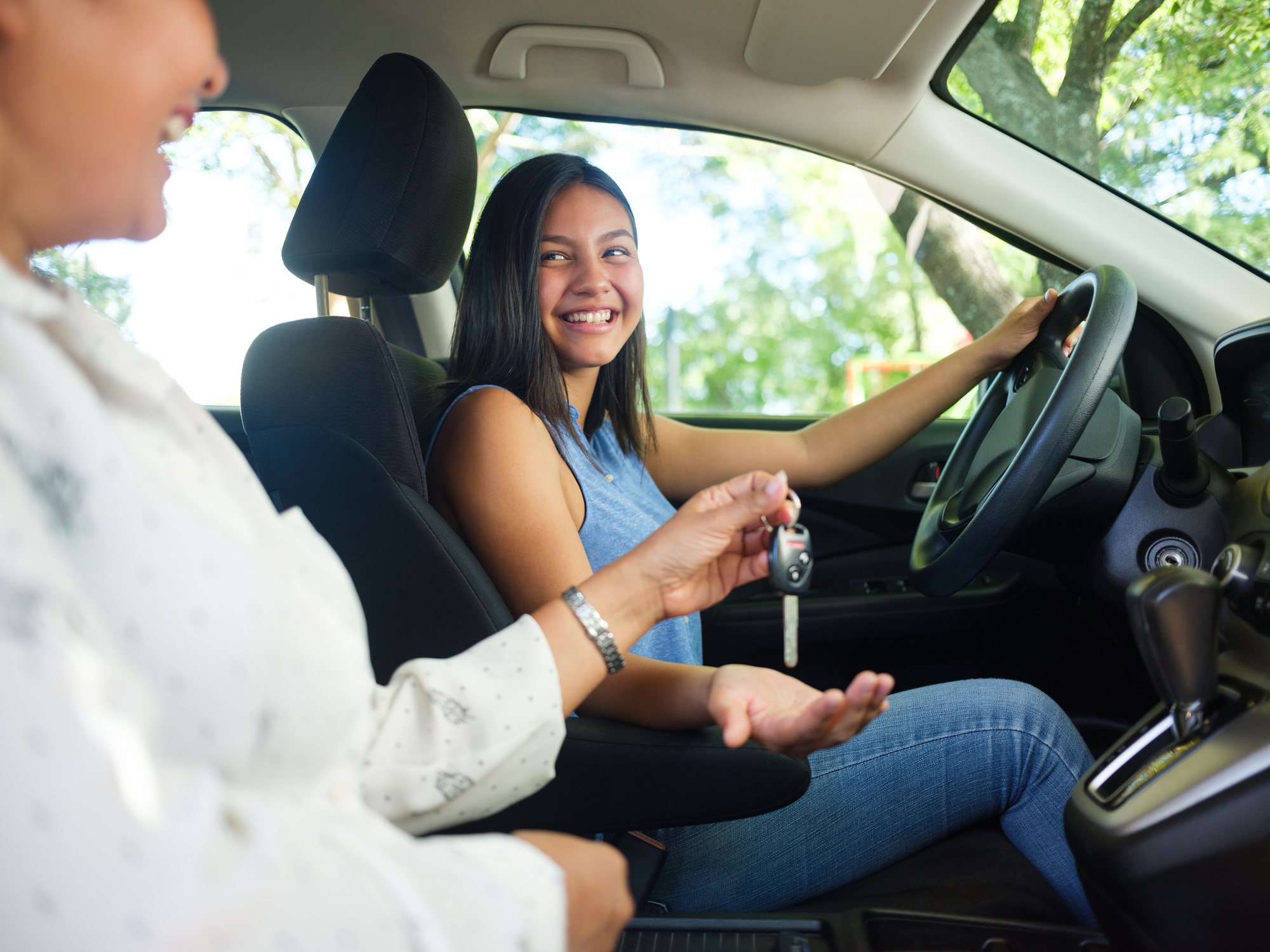 daughter in drivers seat getting keys to first car