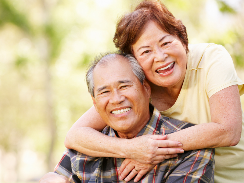 happy elderly couple hugging