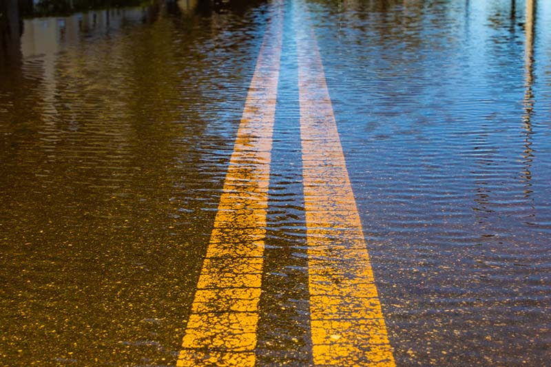 Flooded street with two yellow lines. 