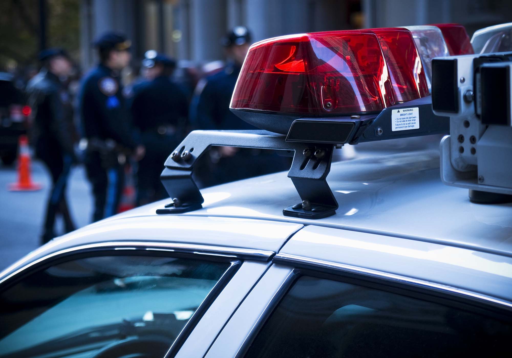 police car light with officers in the background